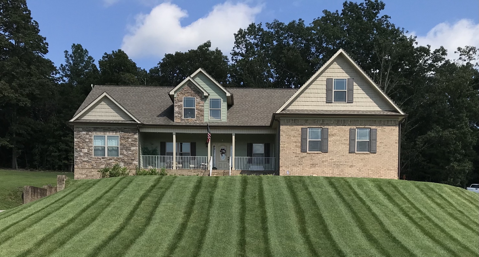 Defined mowing stripes across a front lawn