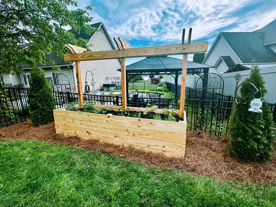 Finished landscape bed with raised garden feature